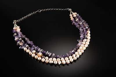 Close-up of pearl jewelry against black background