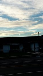 Railroad track against cloudy sky