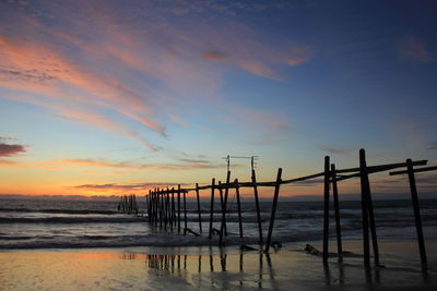 Silhouette pier on sea against sky during sunset