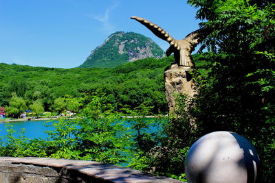 View of cross on mountain against sky