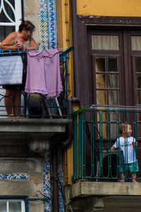 People looking through window in building