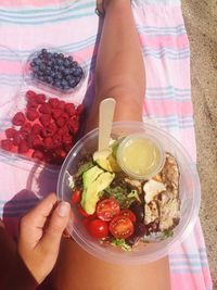 Midsection of woman holding fruits