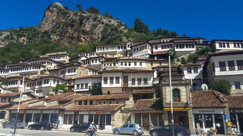 Buildings in city against clear sky