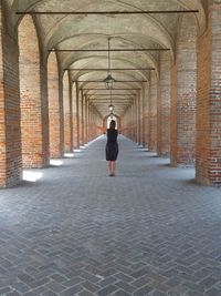 Full length rear view of man walking on building