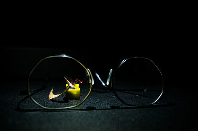 Close-up of sunglasses on table against black background