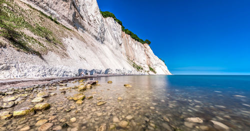 Scenic view of sea against clear blue sky