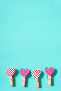 Close-up of heart shapes on turquoise background