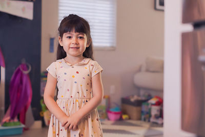 Portrait of girl standing at home