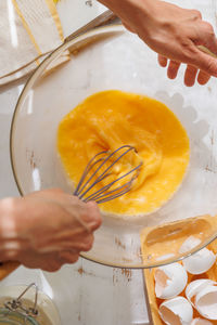 Cropped hands of person preparing food on table