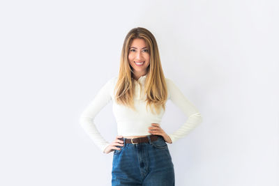 Young woman standing against white background