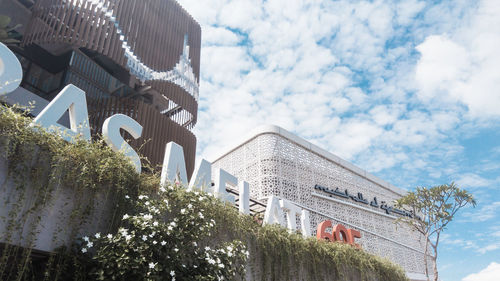 Low angle view of building against cloudy sky