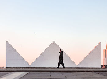 Man and woman against clear sky