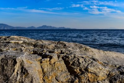 Scenic view of rocks on beach against sky