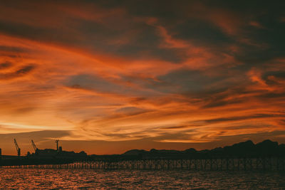 Scenic view of dramatic sky over sea during sunset