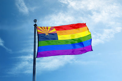 Low angle view of flags against blue sky