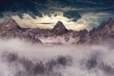 Scenic view of snowcapped mountains against sky during sunset