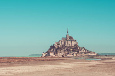 View of temple against clear blue sky