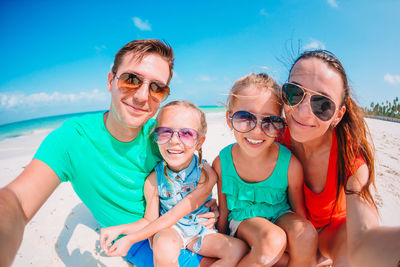 Portrait of family sitting on beach