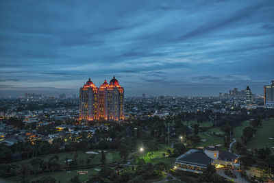 Aerial view of city lit up at dusk