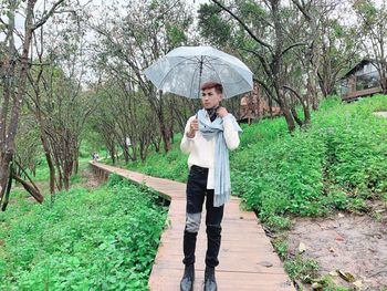 Full length of man standing on rainy day