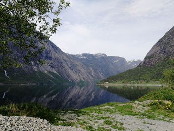 Scenic view of lake and mountains against sky