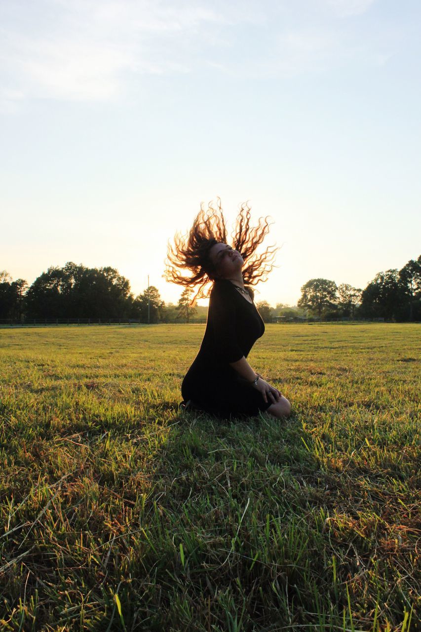 grass, nature, sunlight, tree, field, sunset, landscape, growth, one person, outdoors, sky, beauty in nature, animal themes, day, mammal, people