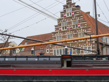 Low angle view of railroad tracks against buildings