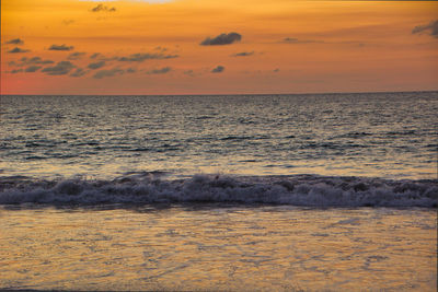 Sunset on the beach, the sun reflects on the sea, in costa rica