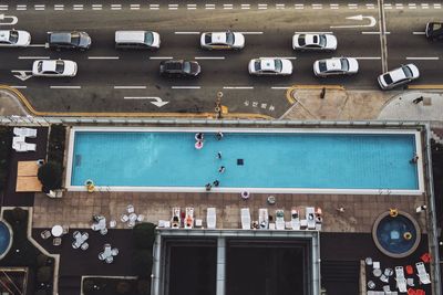 High angle view of cars in parking lot and pool