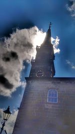 Low angle view of church against cloudy sky