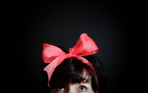 Close-up portrait of a girl against black background