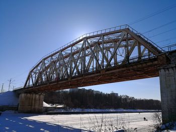 Low angle view of bridge against sky during winter