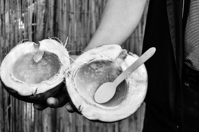Close-up of hand holding coconut
