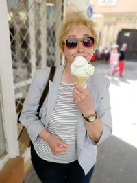 Portrait of woman in sunglasses having ice cream