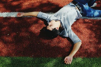 Low section of boy lying on grass