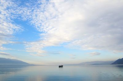 Scenic view of sea against cloudy sky