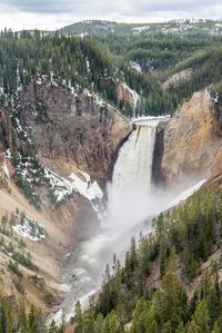 Scenic view of waterfall against sky