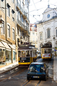 Cars on street amidst buildings in city