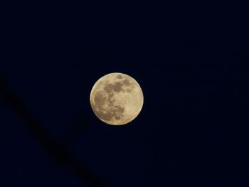 Low angle view of moon against clear sky at night