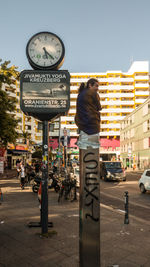 Rear view of woman walking on street in city