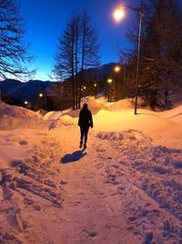 Man walking on snow covered land