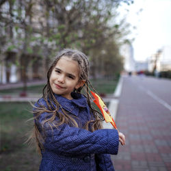 Portrait of girl standing on street