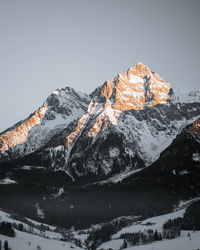 Scenic view of snowcapped mountains against clear sky