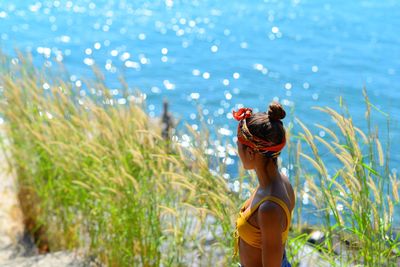 Rear view of woman standing in water