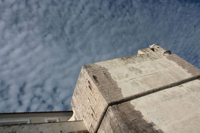 High angle view of old building by sea against sky