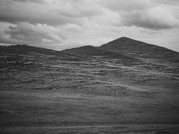 Scenic view of landscape against cloudy sky