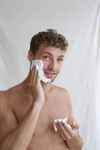 Midsection of shirtless baby boy in bathroom