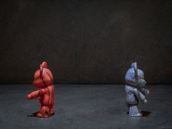 Statue of person with toy on wall