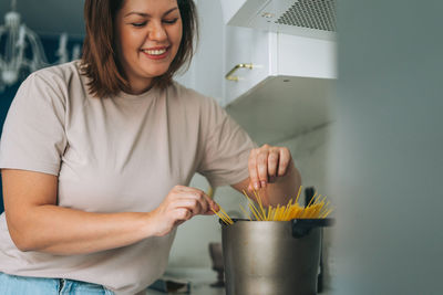 Mid adult woman standing at home