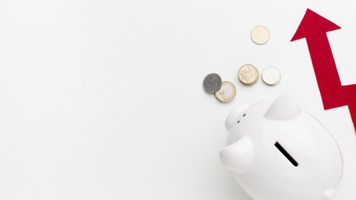 High angle view of coins on white background